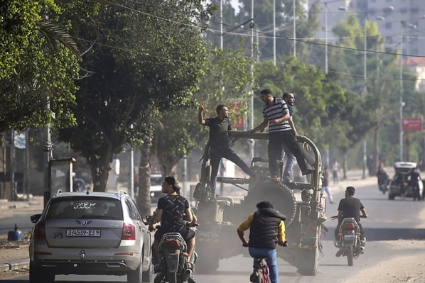 Des militants palestiniens qui ont capturé un véhicule militaire israélien le 7 octobre 2023